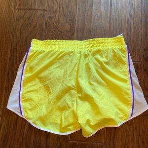 Nike yellow with purple lining shorts. Size S